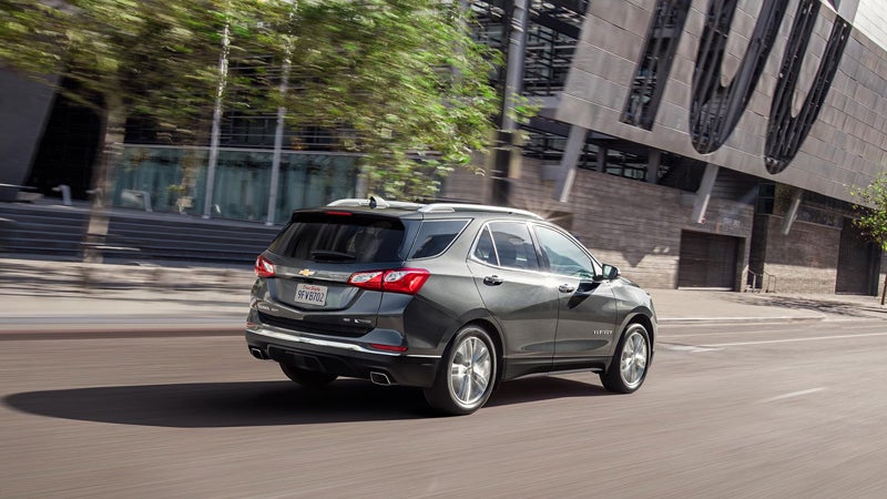 Grey Chevrolet running on road