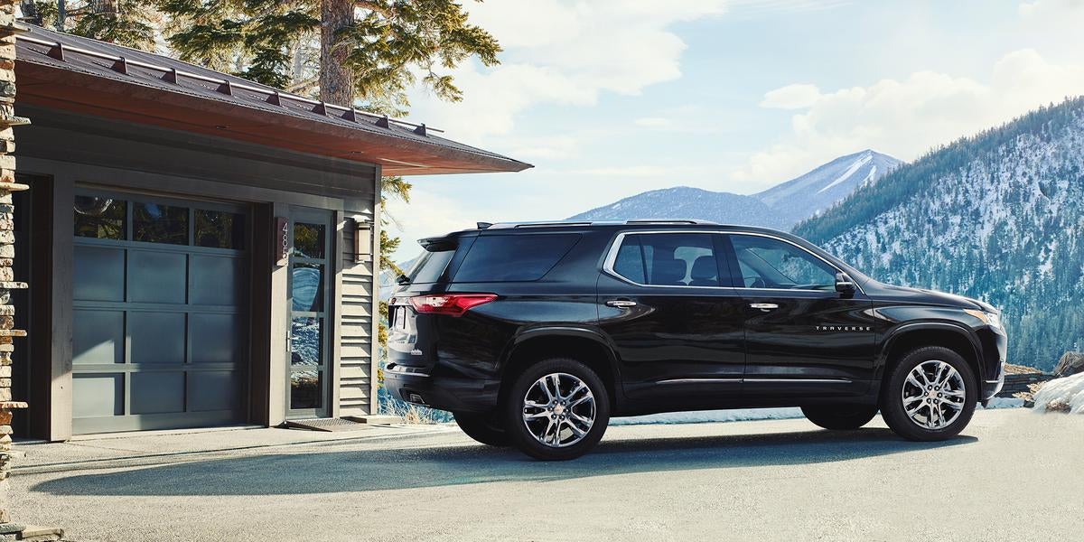 Traverse black running on road with background mountain